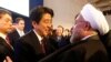 FILE PHOTO: Japan's Prime Minister Shinzo Abe greets Iran's President Hassan Rouhani (R) during the annual meeting of the World Economic Forum (WEF) in Davos January 22, 2014. REUTERS/Denis Balibouse/File Photo