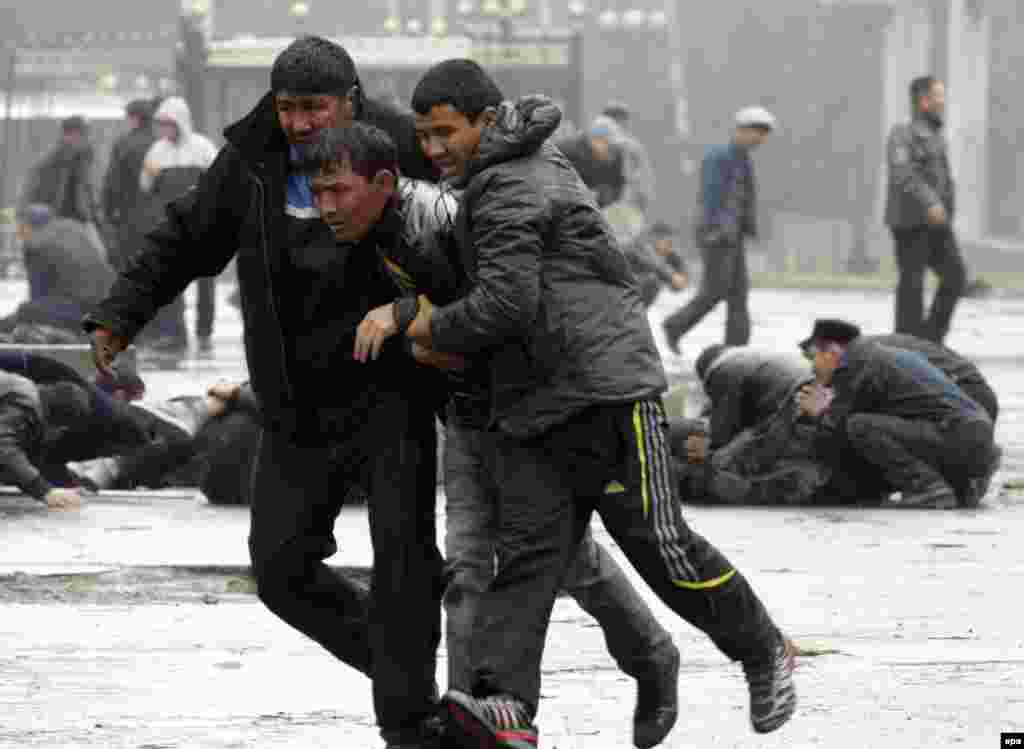 Protesters run for cover in the midst of the clashes.