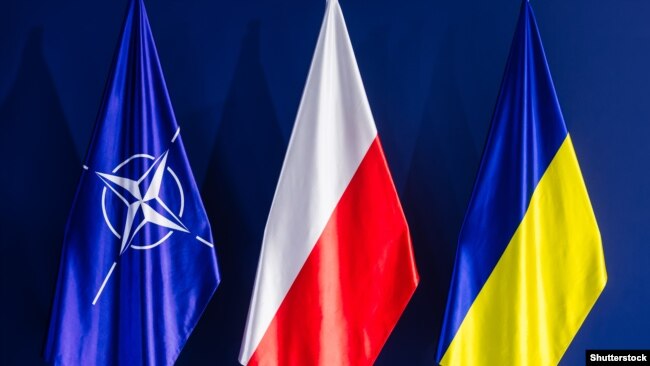 The flags of NATO, Poland, and Ukraine. Poland, the largest country on NATO's eastern flank, finds itself increasingly targeted by Moscow's intelligence services as Russia's invasion of Ukraine continues.