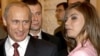 Russian President Vladimir Putin (left) smiles next former Russian gymnast and former Duma deputy Alina Kabayeva, with whom he has been romantically linked. According to the Reuters news agency Kabayeva was implicated in a report on alleged connections between a shadowy Putin-connected businessman and several women in the president's life. 