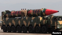 Pakistani military personnel stand beside a Shaheen-III surface-to-surface ballistic missile during a military parade. (file photo)