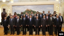 Chinese President Xi Jinping (center-front) poses for photos with the guests of the Asian Infrastructure Investment Bank (AIIB) in the Great Hall of the People in Beijing in October 2014.