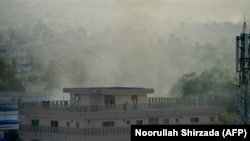 Smoke rises near a government building attacked by suicide bombers and gunmen in Jalalabad on September 18.