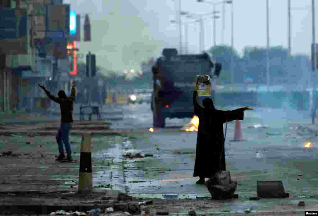 Two Bahraini protesters confront riot police during a demonstration to mark the 6th anniversary of the February 14 uprising in 2011. (Reuters/Hamad I Mohammed)