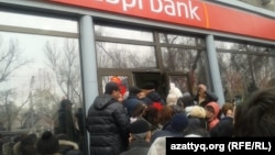 The tenge's devaluation has triggered a series of public protests in Almaty, as well as a bank run by panicked savers on three private banks on February 18.