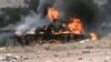 Syria -- An image grab taken from a video uploaded on YouTube on July 25, 2012 allededly shows a burning Syrian army tank after it was purpotedly hit by rebels in the central city of Rastan