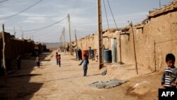 Afghan children wander at the Shahid Nasseri refugee camp in Taraz Nahid, some 130 km southwest of the capital Tehran, in February 2015.