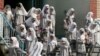 File photo:Iranian girls head home after classes end at Sizdah Abban school in north of Tehran 01 October 2006. (Photo by ATTA KENARE / AFP)