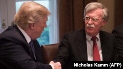 File photo - U.S. President Donald Trump shakes hands with National Security Advisor John Bolto during a meeting with senior military leaders at the White House in Washington, April 9, 2018