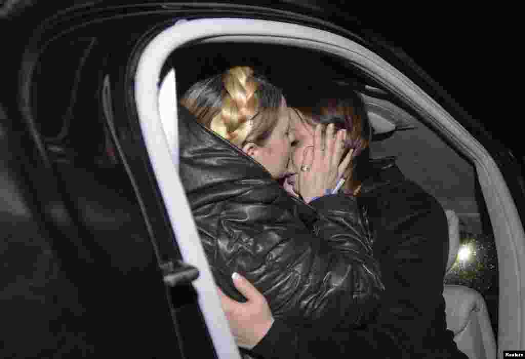 Ukrainian opposition leader Yulia Tymoshenko (left) hugs her daughter Yevhenia upon her arrival at the airport in Kyiv, shortly after she was released from a prison hospital on February 22. (Reuters/Andrew Kravchenko)