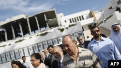 Richard Goldstone (right) walks with Hamas deputy Ahmed Bahr (left) and members of his delegation as they visit the Palestinian parliament building that was destroyed during Israel's December-January offensive in Gaza City.