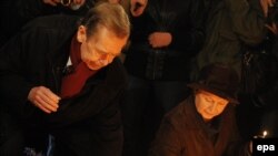 Former President Vaclav Havel lights a candle at a memorial in downtown Prague on November 17 to students whose protests launched the ouster of communism in 1989.