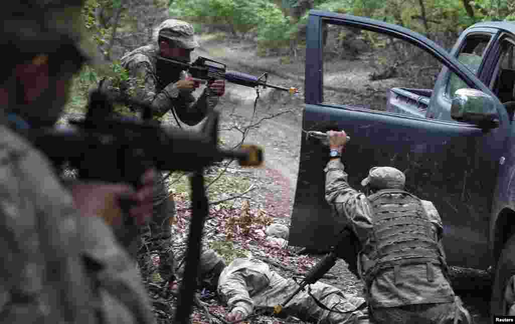 Candidates take part in a military exercise during the selection process for the Georgian Army Special Forces outside Tbilisi. (Reuters/David Mdzinarishvili)