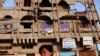 A boy walks past a building in Sadr City, damaged during the 2003 U.S. invasion that toppled Iraqi President Saddam Hussein.