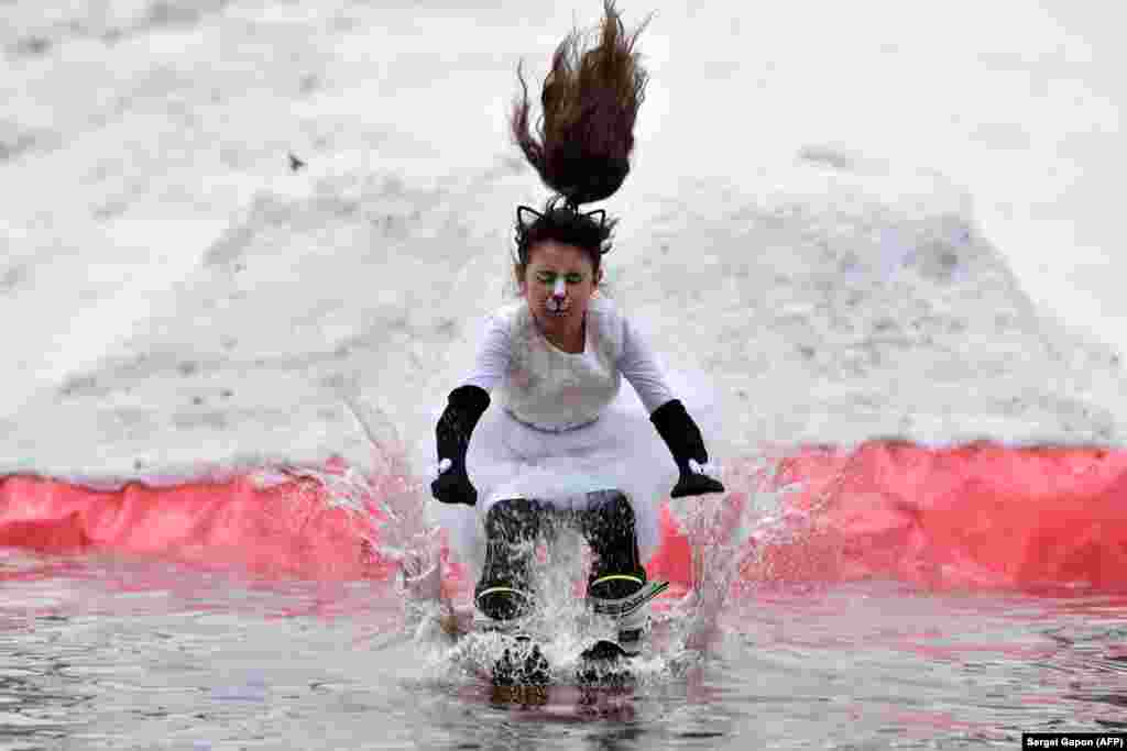 A costumed participant skis on a pool as part of the Californication 9.0 humoristic competition marking the end of the winter season outside the town of Lahoysk, Belarus, on April 7.&nbsp;(AFP/Sergei Gapon)