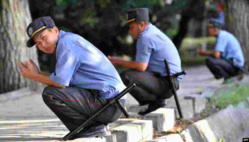 Policemen pray in a square in central Bishkek, Kyrgyzstan.