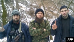 North Caucasus insurgency leader Doku Umarov (center) poses with Emir Muslim (left) and Emir Imam.