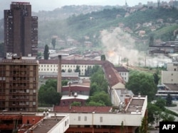 Shells hit houses in the suburbs of Sarajevo in August 1992.