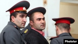 Armenia -- Police officer Ashot Harutiunian is led away from the courtroom after being sentenced to eight years in prison for torture, 29Nov2010.
