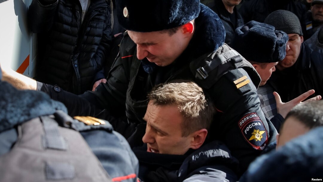 Police detaining Navalny on March 26 in Moscow.