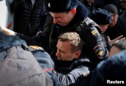 Russian police detain opposition leader Aleksei Navalny on March 26.