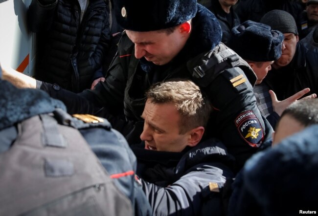 Russian police detain opposition leader Aleksei Navalny on March 26.