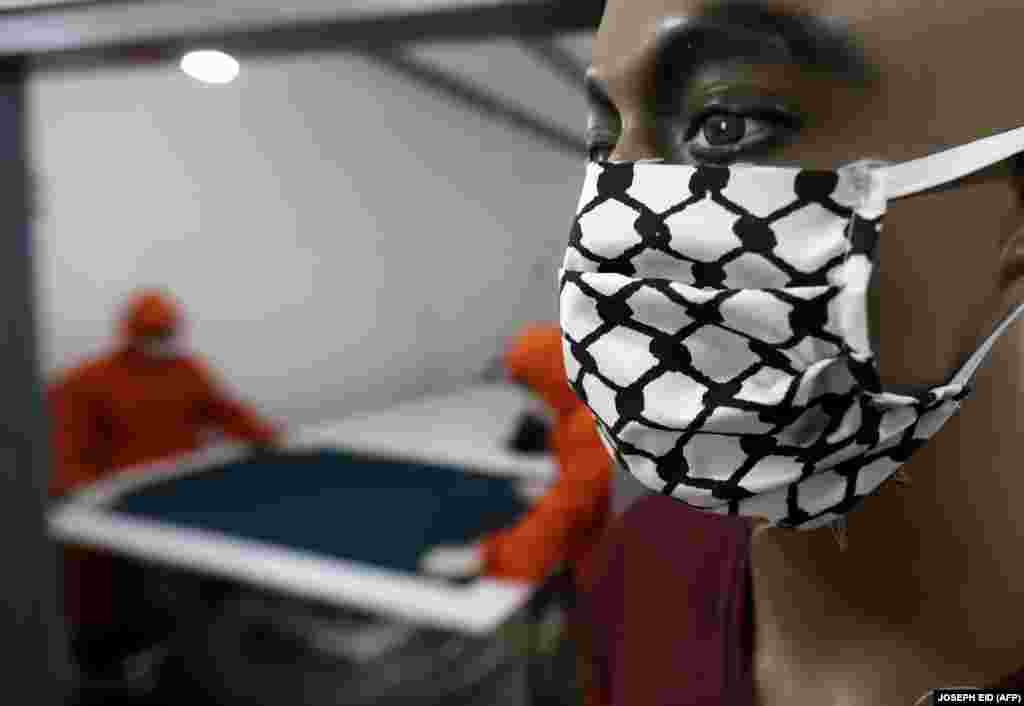 A mannequin wears a face mask with the checkered patterns of the kaffiyeh, the scarf worn by Palestinians to symbolize struggle. This mask was on display at a Palestinian tailor&#39;s workshop in the Burj al-Barajneh refugee camp in Lebanon.