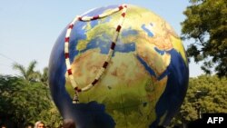 Greenpeace activists carry a globe during a mock funeral procession in New Delhi in December.