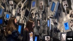 Disa vajza shikojnë portretet e hebrenjve, të vrarë gjatë Holokaustit, në Qendrën Përkujtimore për Hebrenjtë, në Shkup të Maqedonisë. 24 prill, 2017