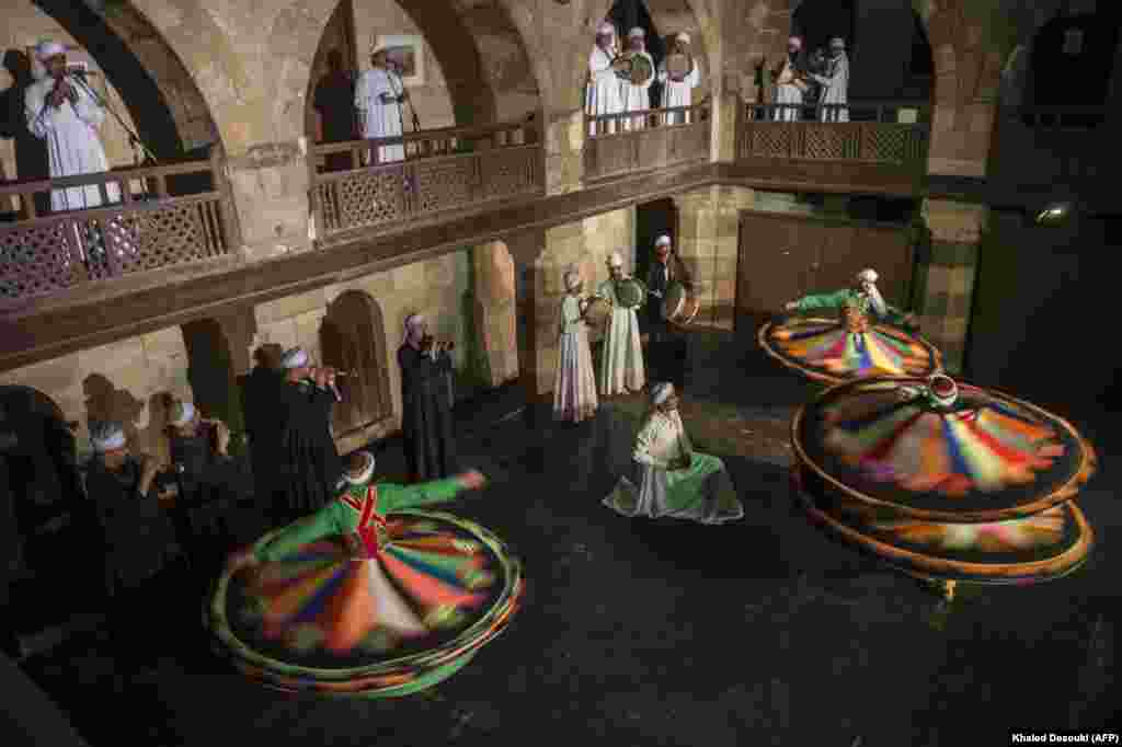 Egyptian dancers perform the Tanoura during the holy fasting month of Ramadan at the El-Ghuri Culture Palace in Cairo. (AFP/Khaled Desouki)