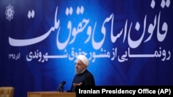In this December 2016 photo, President Hassan Rouhani is seen unveiling a "Citizens' Rights Charter", which has remained on paper, as repression continues. 