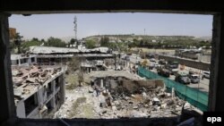 Workers remove debris from a damaged area on June 1 a day after a suicide bomb attack near the foreign embassies in Kabul.