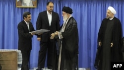 Exiting President Mahmud Ahmadinejad (left) handed the official endorsement document to Supreme Leader Ayatollah Ali Khamenei (second from right) on August 3 as President-elect Hassan Rowhani (right)) looked on.