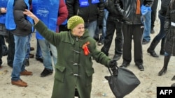 An elderly supporter of Viktor Yanukovych dances as she celebrates the election results during a rally in front of the Central Election Commision in Kyiv today.