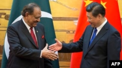 Pakistani President Mamnoon Hussain (left) attends a signing ceremony with Chinese President Xi Jinping in Beijing on February 19. 