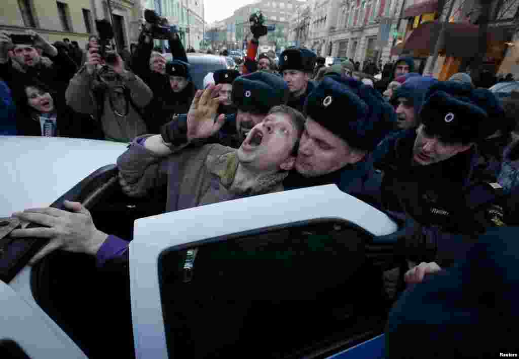 Police officers detain a demonstrator who was taking part in a protest by foreign-currency mortgage-holders near Central Bank headquarters in Moscow on February 8. (Reuters/Sergei Karpukhin)