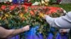 Ukrainians lay flowers on a rainbow flag at the U.S. Embassy in Kyiv on June 13 in honor of the victims of the mass shooting in Orlando.&nbsp;