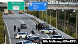 DENMARK -- Police vehicles block the street leading to the Oeresund Bridge near Copenhagen, September 28, 2018