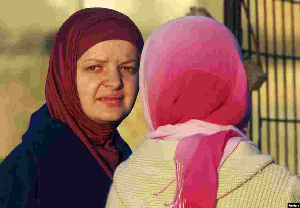 Ethnic Albanian women wait near the bus in Presevo.