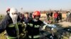 Rescue workers carry the body of a victim of an Ukrainian plane crash in Shahedshahr, southwest of the capital Tehran, Iran, Wednesday, Jan. 8, 2020.