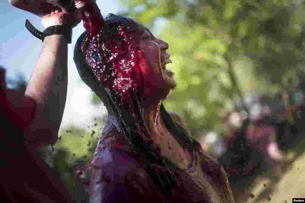 Revelers participate in the Batalla de Vino (Wine Battle) in Haro, on northern Spain. Every year thousands of people celebrate the day of the patron saint of the town, San Pedro, with a trek to the mountainous crags of Bilibio. Following a mass in honor of the fifth century hermit, St. Felices de Bilibio, a giant battle ensues with participants using any method available to soak each other with cheap wine.(Reuters/Vincent West)