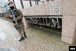 A Belgian soldier guards the streets near the meeting of foreign ministers in Brussels.