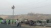 Pakistan -- Pakistani residents watch from a road the five-star Pearl Continental hotel, located on a hill (top back) in the southwestern Pakistani city of Gwadar, on May 11, 2019. 