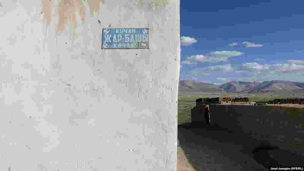 The street name is written in Kyrgyz and Tajik. Usually, only the Tajik language is used on public signage. Beyond the mountains in the background lies Afghanistan.