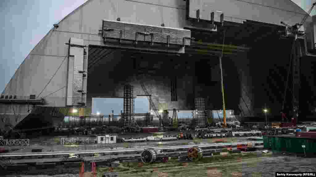 Construction of the New Safe Confinement (NSC) is complete. In mid-November, the giant steel structure will start sliding into place over Chernobyl's old crumbling concrete sarcophagus. The end walls that will seal the covering will be built in 2017. When finished, the confinement structure is expected to keep radiation from leaking for the next 100 years.
