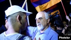 Armenia - Paruyr Hayrikian (R) argues with a protester on Marshal Bagramian Avenue, Yerevan, 2Jul2015.