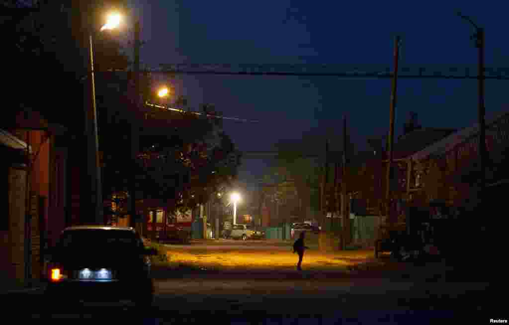 A boy walks along a street in Chiri-Yurt.