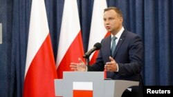 Polish President Andrzej Duda speaks to reporters at the Presidential Palace in Warsaw on July 24.