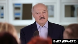 Alyaksandr Lukashenka talks to medical workers during a visit to a district hospital in Stolbtsy on December 8. Even before the election in August, his handling of the coronavirus pandemic angered many in Belarus.