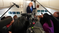 US President Donald Trump speaks to reporters aboard Air Force One on August 2.